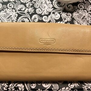 Coach tan folding quality leather wallet with turn key closure. Like new.